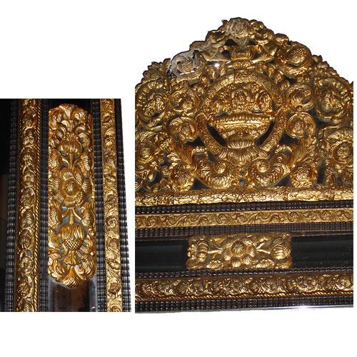  A Fine Flemish Brass Repousse and Ebonized Carved Wood Mirror