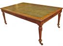 A Carved Mahogany Table with Green Leather Top