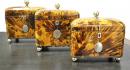 A Set of Three Blonde Tortoiseshell Tea Caddies of Graduating Sizes