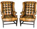 A Custom Pair of Tufted Leather Wing Chairs